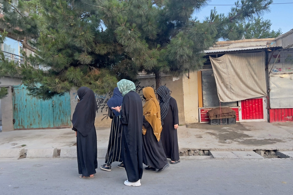 In this photo taken on June 26, 2024, Afghan women walk along a road in Kabul early in the morning. - AFP image